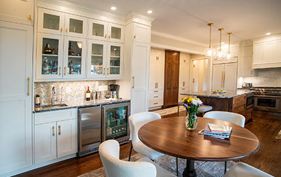 cozy bar area with white chairs at a round table