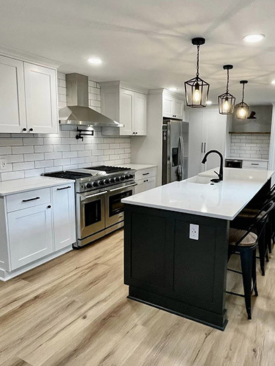 modern kitchen with wood floor and white and black accents