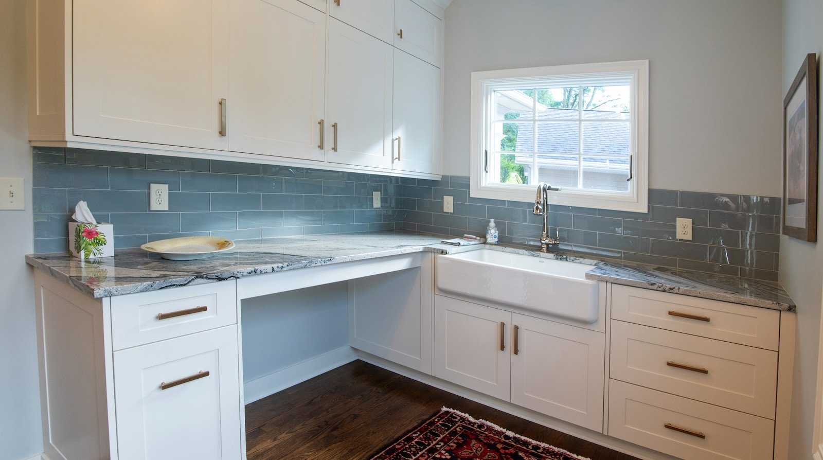 customer white countertops and blue subway tile in laundry room
