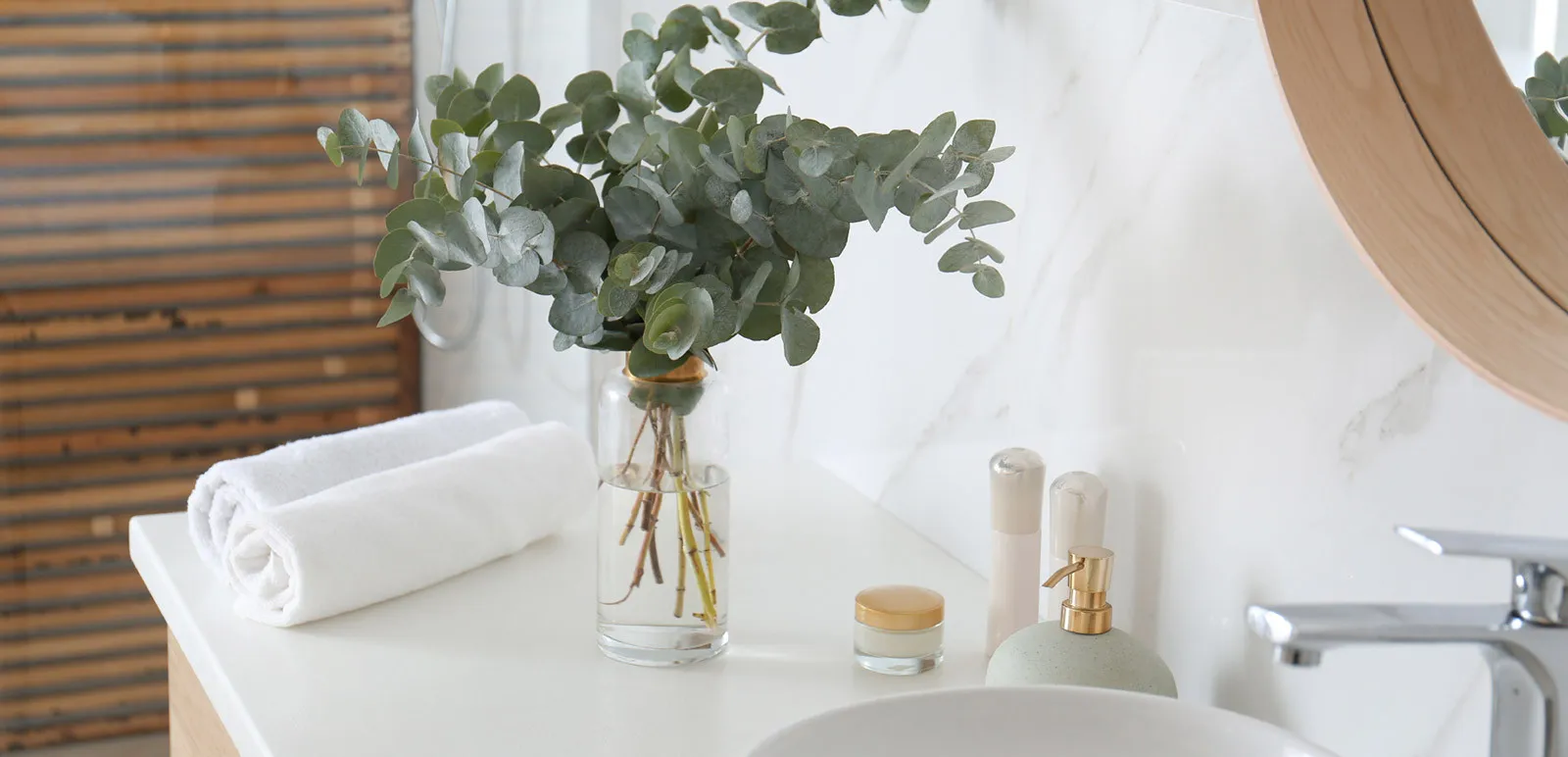 vase of greenery on a bathroom sink