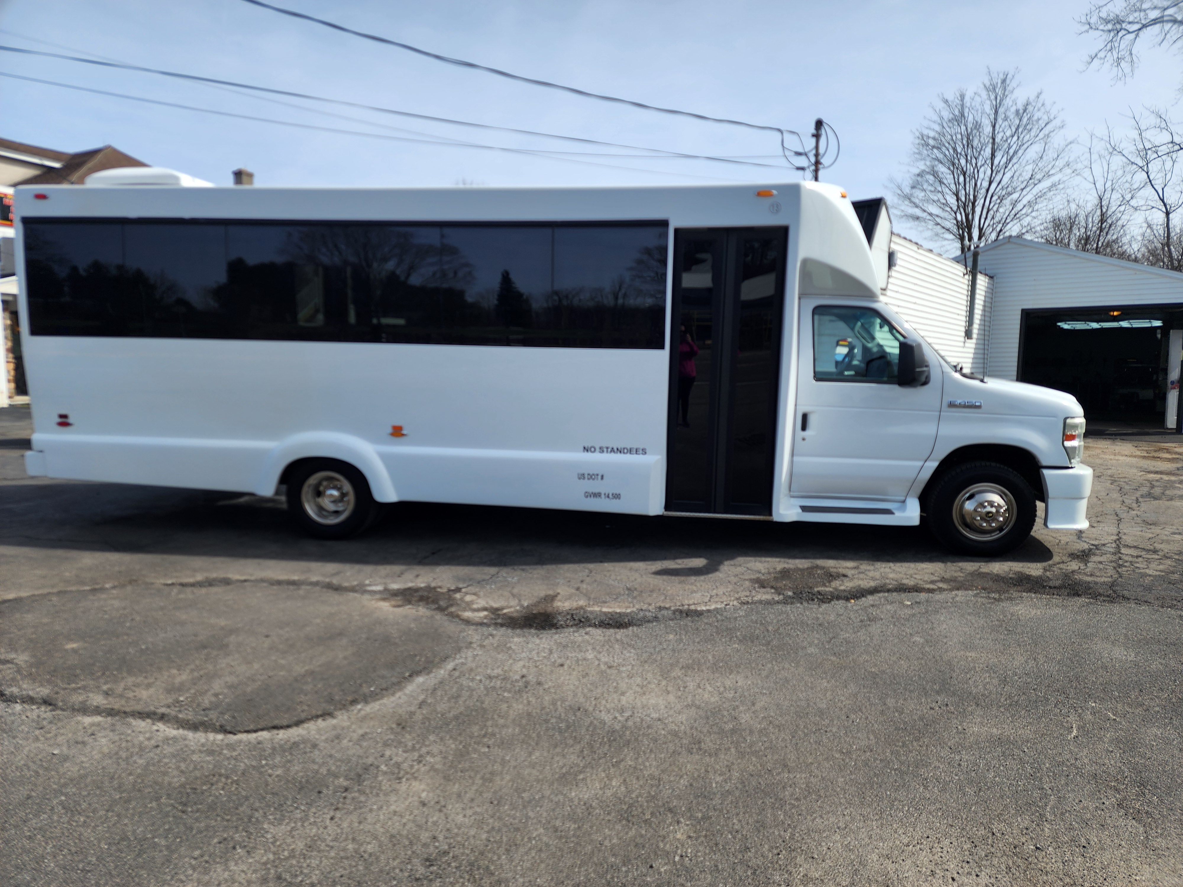 classy coach transportation white limo bus from passenger exterior side
