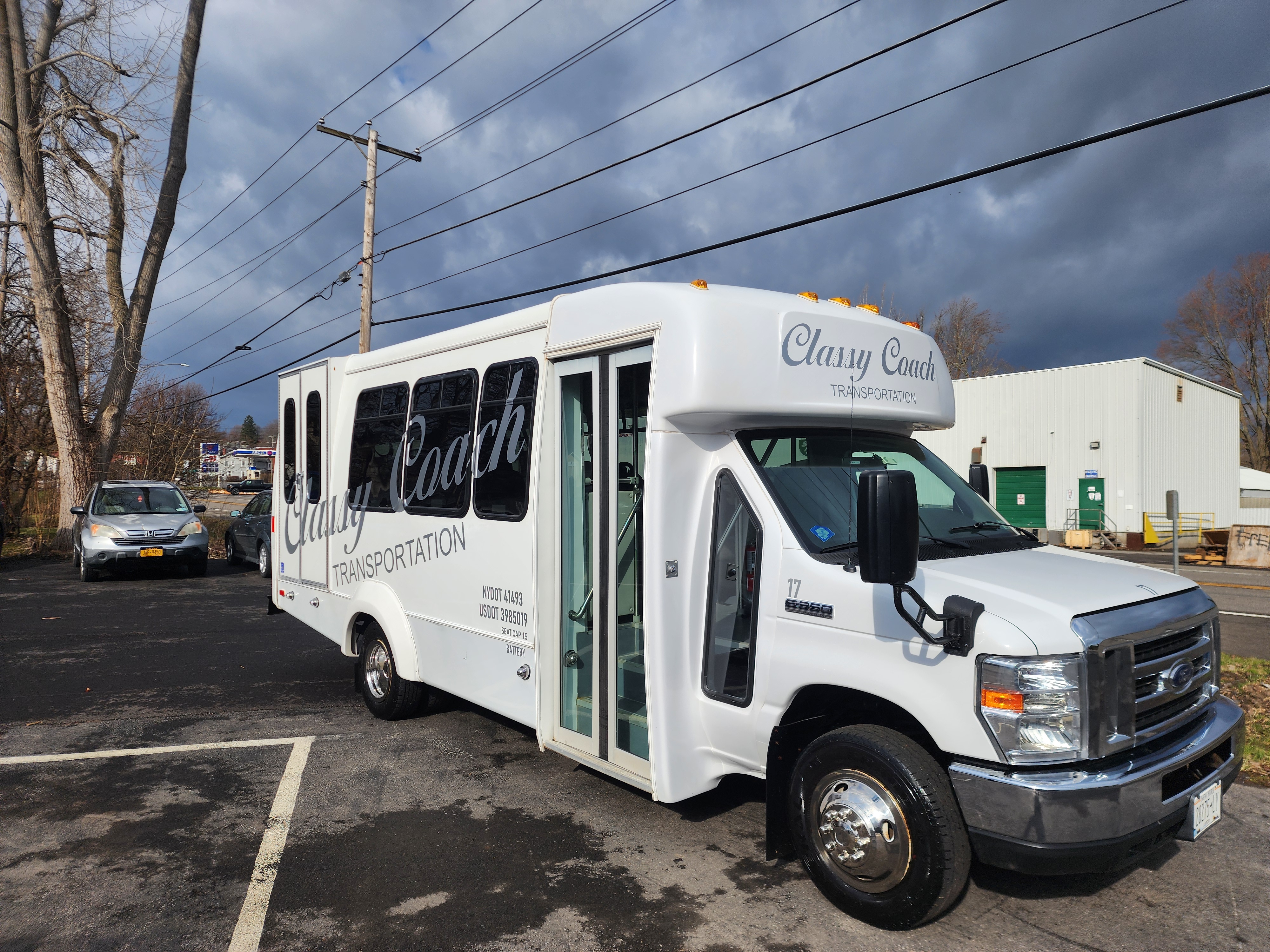 classy coach white ada accessible passenger bus front side view
