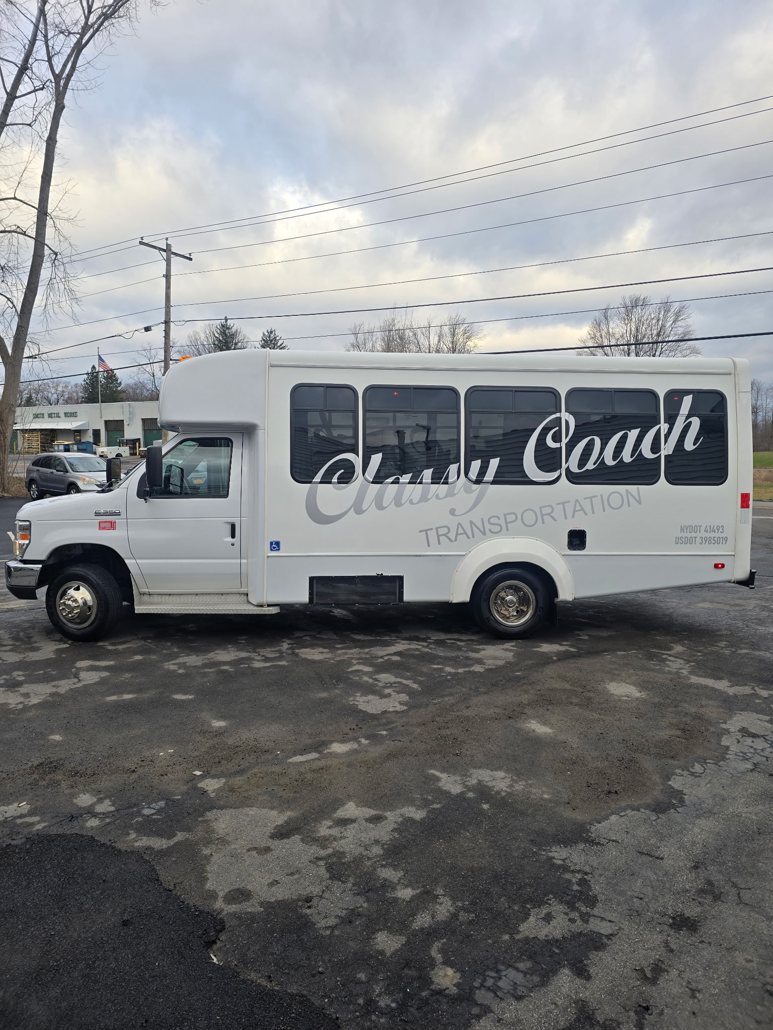 driver side view of ada accessible passenger bus from classy coach