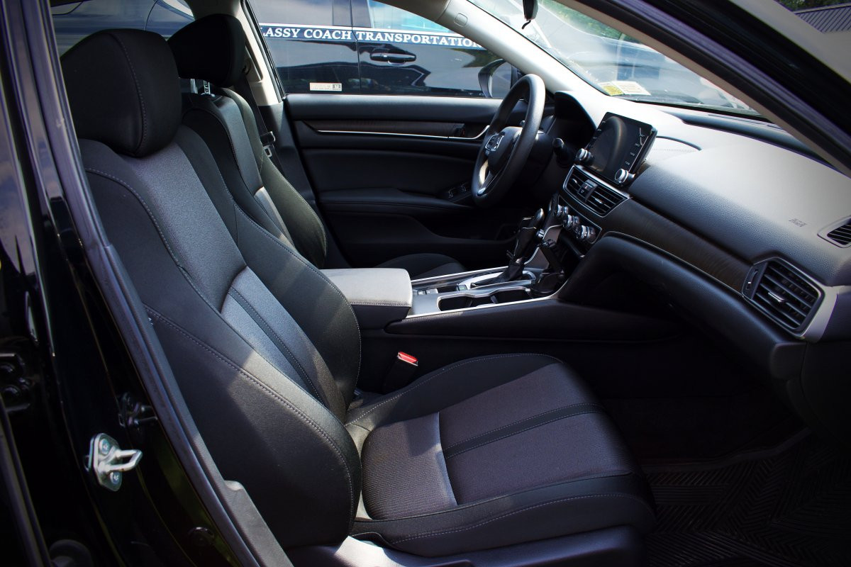 classy coach transportation black sedan front seat