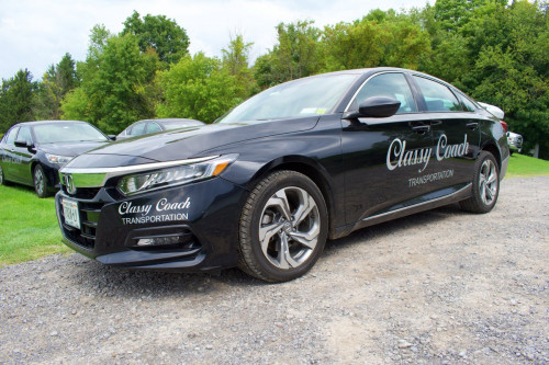 black sedan classy coach transportation
