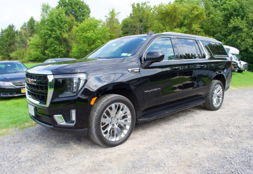 angled exterior of black classy coach yukon