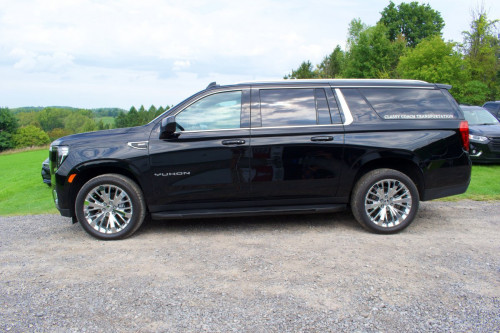 side view of black classy coach yukon