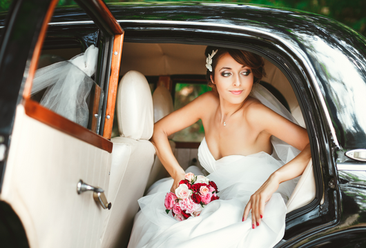 Girl getting out of a wedding limo