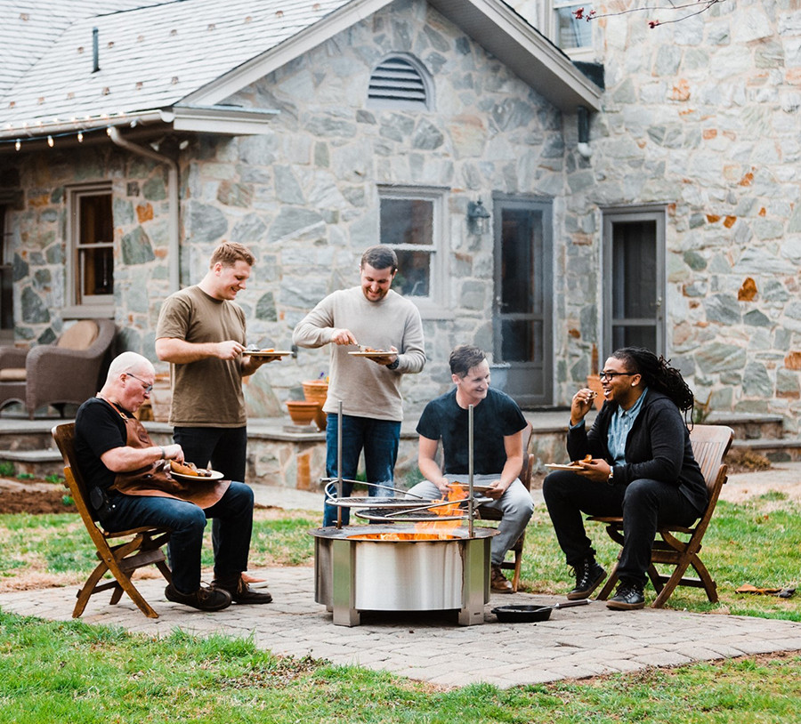 people eating by a fire pit