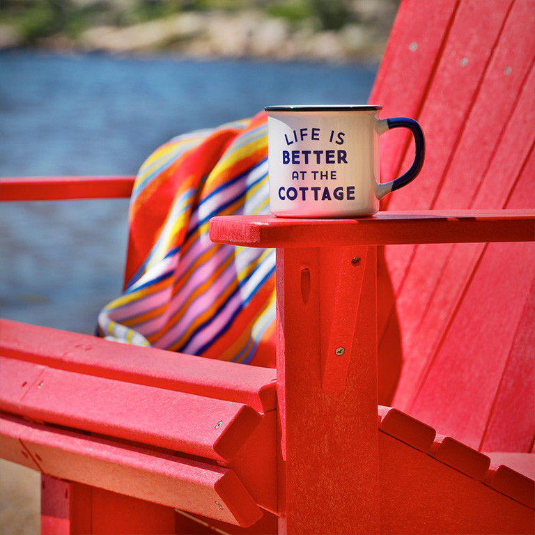 mug on red adirondack chair