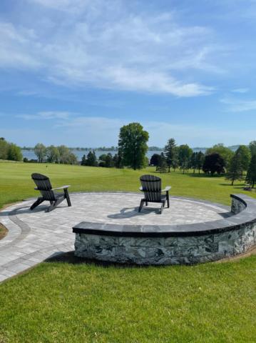 adirondack chairs overlooking a lake on a patio