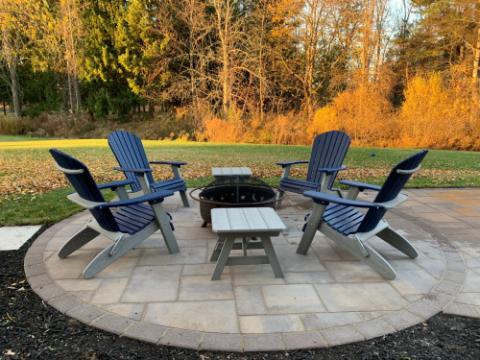 adirondack chairs around a fire pit