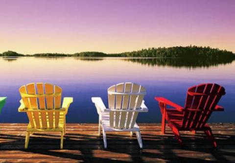 colored adirondack chairs overlooking a lake