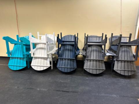 colored adirondack chairs on top of each other