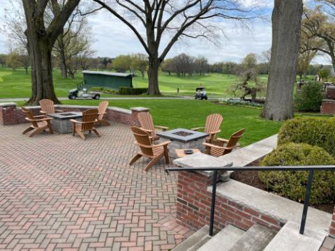 adirondack furniture on a brick patio