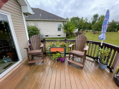 brown adirondack chairs on a deck