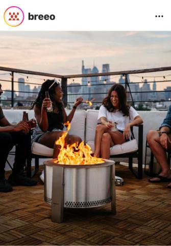 laughing by a fire pit on a comfy sofa