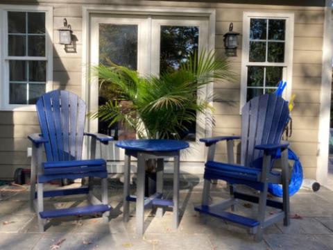 blue adirondack chairs with a table