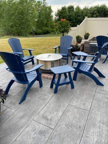 blue adirondack chairs around a fire pit