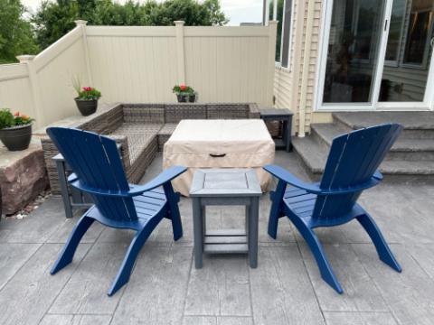 blue adirondack chairs with a grey table