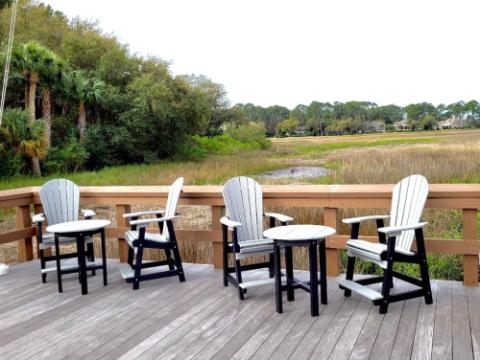 grey adirondack chairs with tables