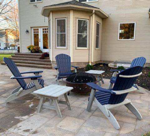 blue adirondack chairs around a firepit