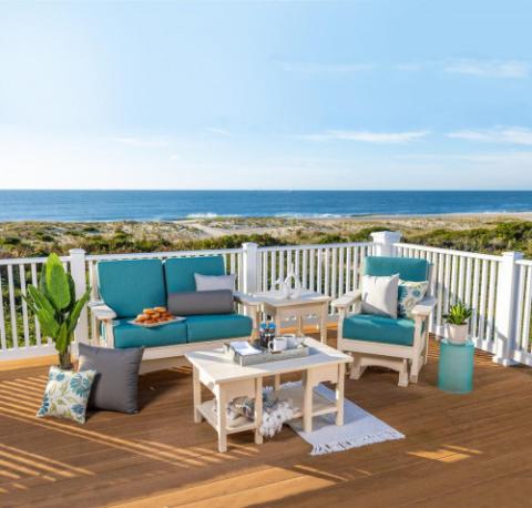 set of white adirondack furniture with blue cushions