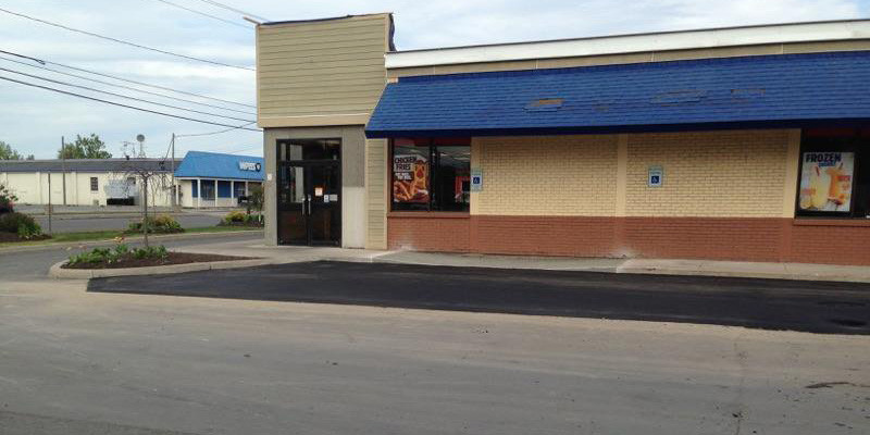 A parking lot outside of a fast food restaurant.