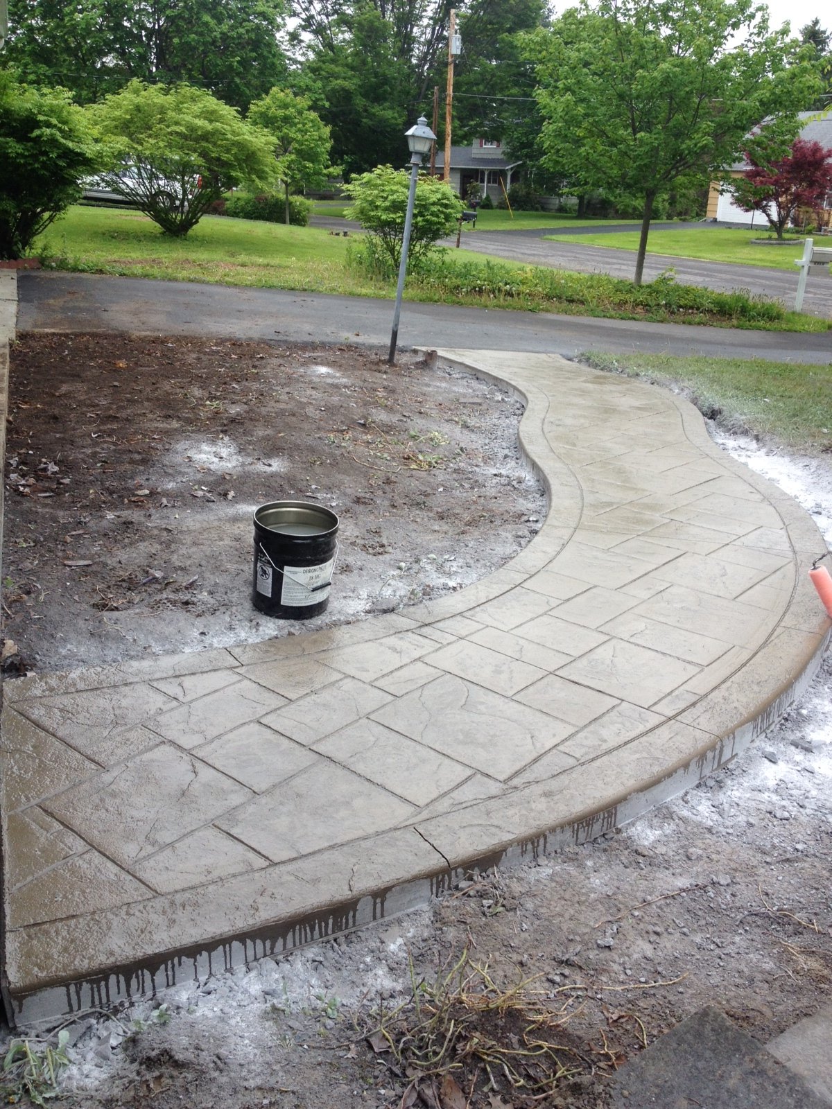 A new stone walkway in front of a house.