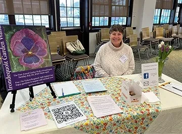 Volunteer welcoming visitors at Irondequoit Garden Walks.
