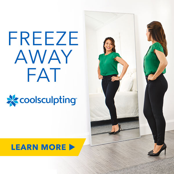 woman admiring results of her coolsculpting treatment in the mirror