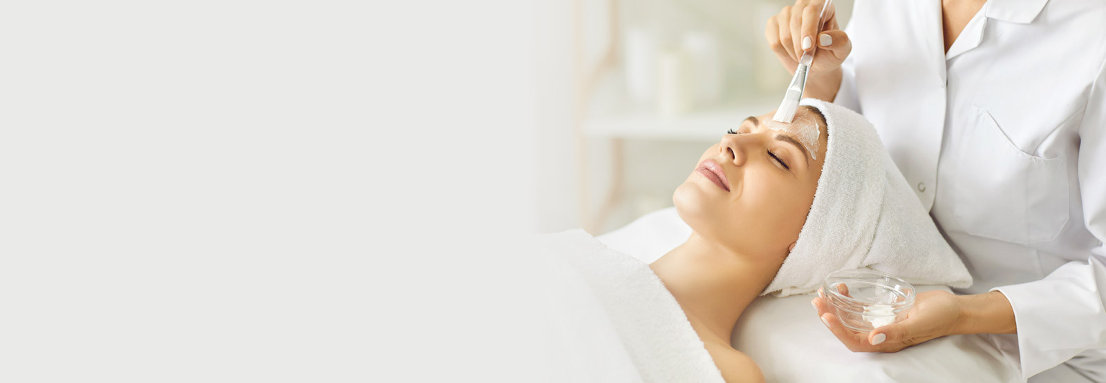 woman appearing very peaceful as she receives a facial treatment