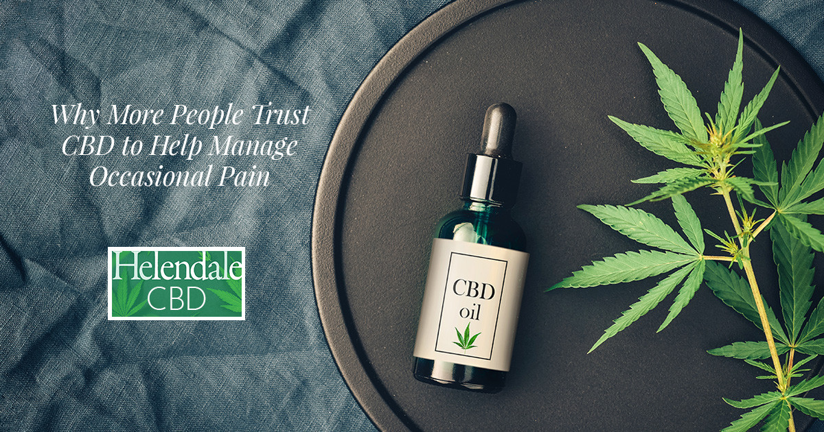 A CBD oil dropper bottle and hemp leaves on a dark tray, with text about managing pain.