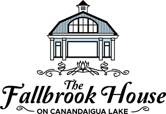 logo of The Fallbrook House, featuring a barn illustration and floral design elements