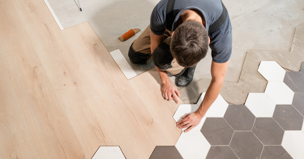 man installing tile floor