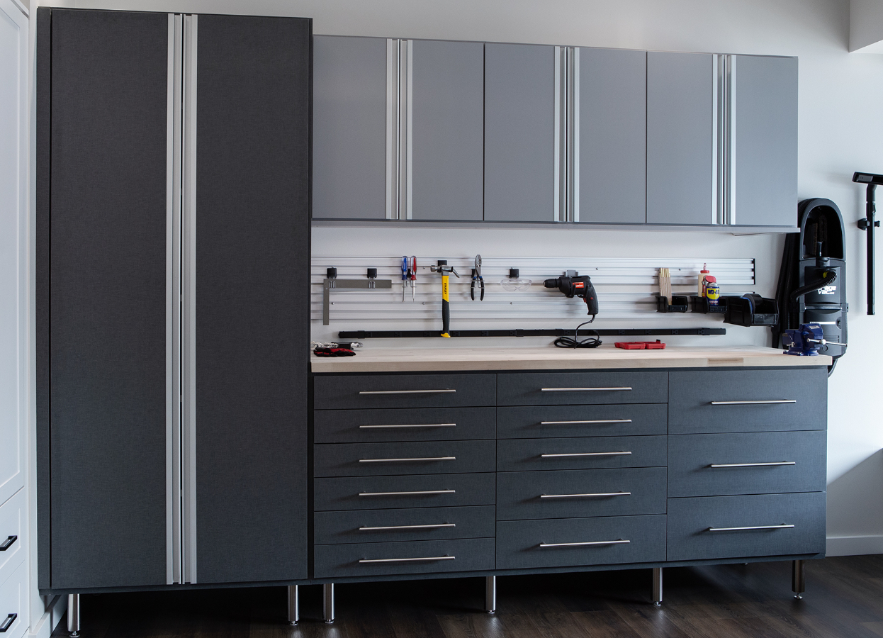 Grey storage cabinets and tool organization in garage