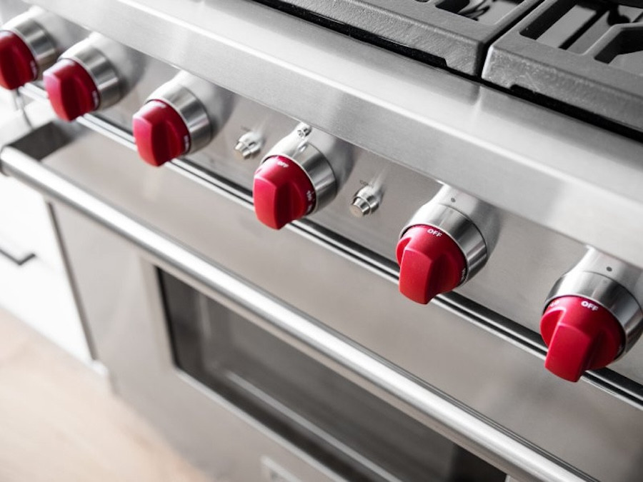 stainless steel stove with red knobs