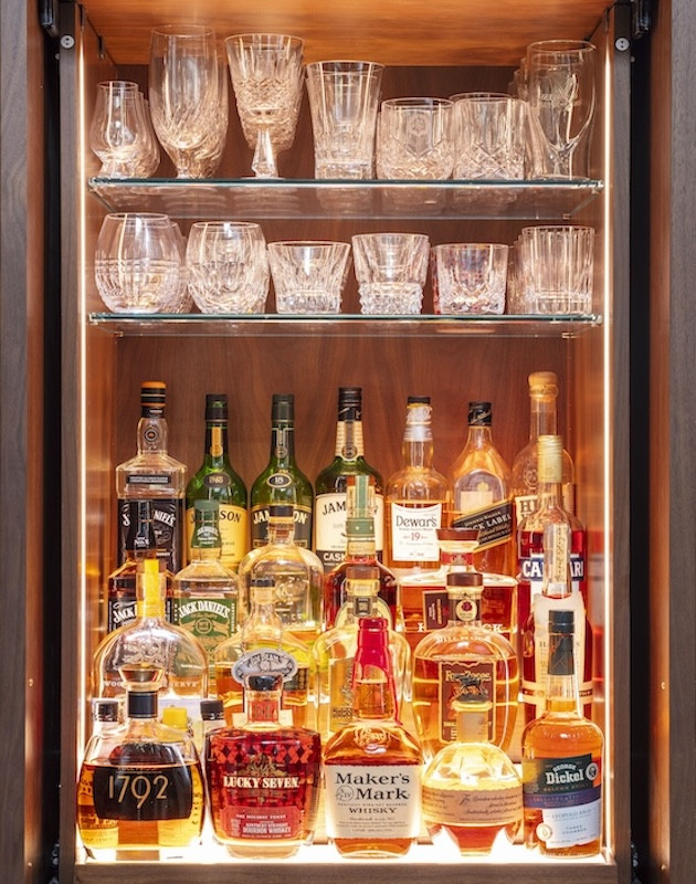 liquor bottles and glassware on shelf