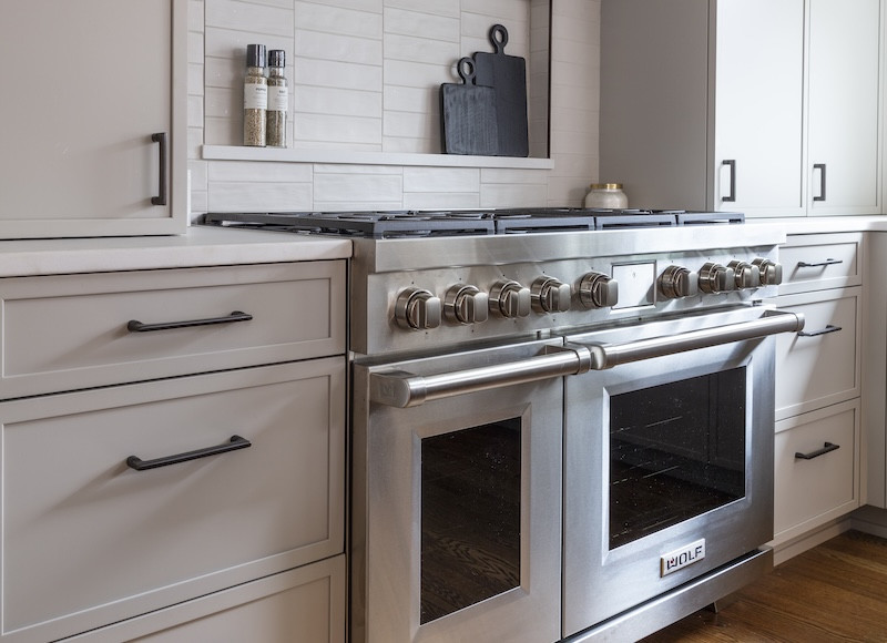 gray kitchen cabinets with stainless oven