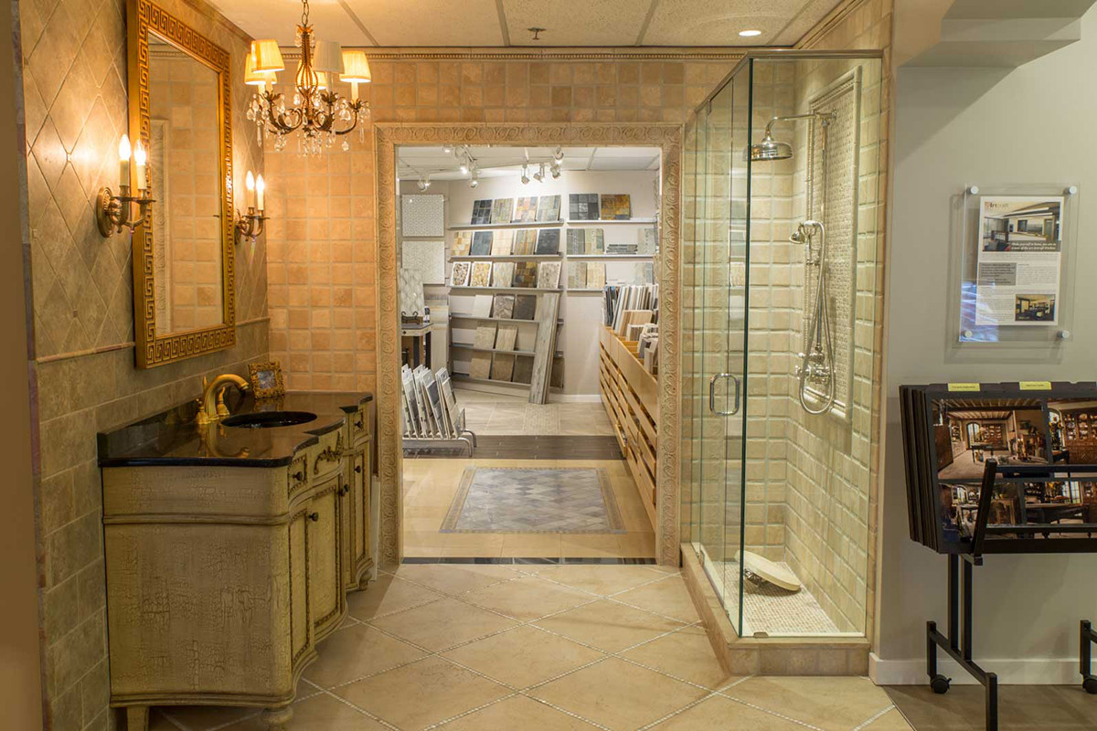 A bathroom sink and shower stall on display in a showroom.