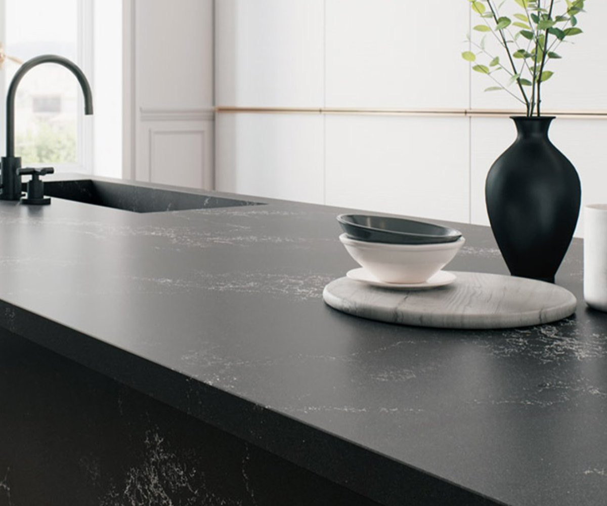 black Caesarstone countertop with vase and bowls