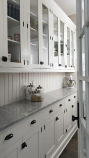 White kitchen cabinetry and marble countertops
