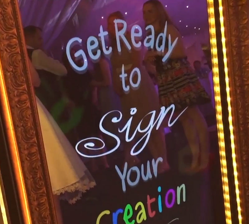 Mirror Photo Booth Displaying Get Ready to Sign Your Creation