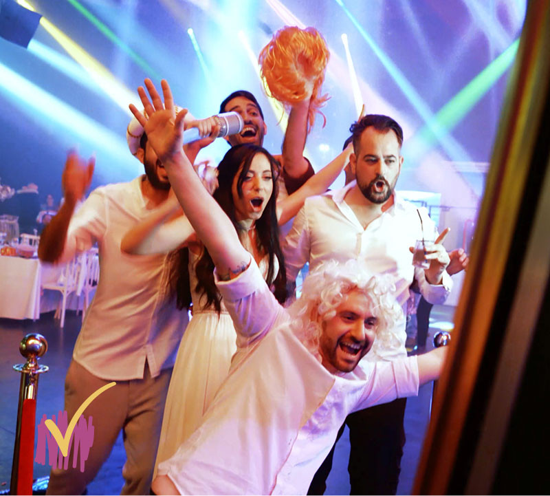 Five People Holding Fun Props Enjoying Mirror Photo Booth