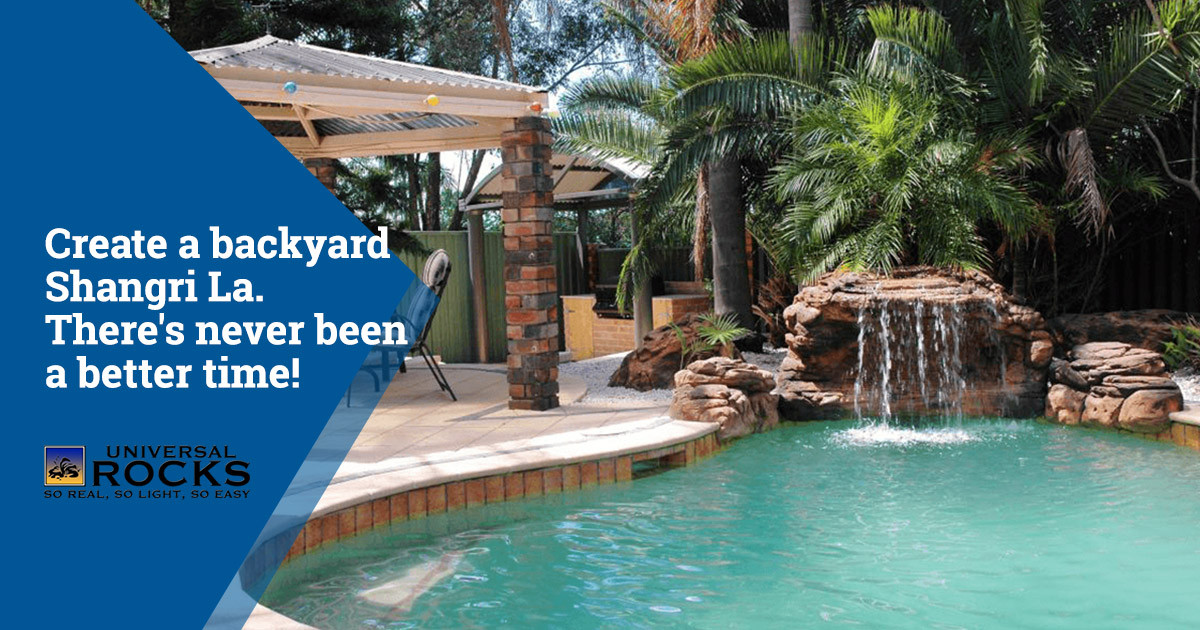 In-ground pool with faux rock waterfall