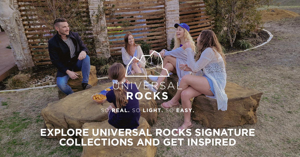 A group of five friends sitting on large rocks and talking and laughing together