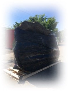 artificial rock spa wrapped in black plastic on pallet for shipping