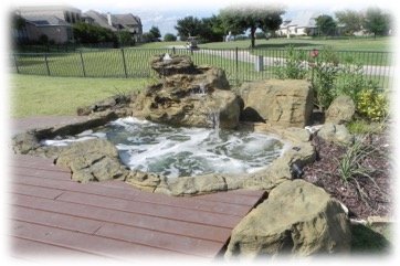 faux rock spa in backyard with waterfall