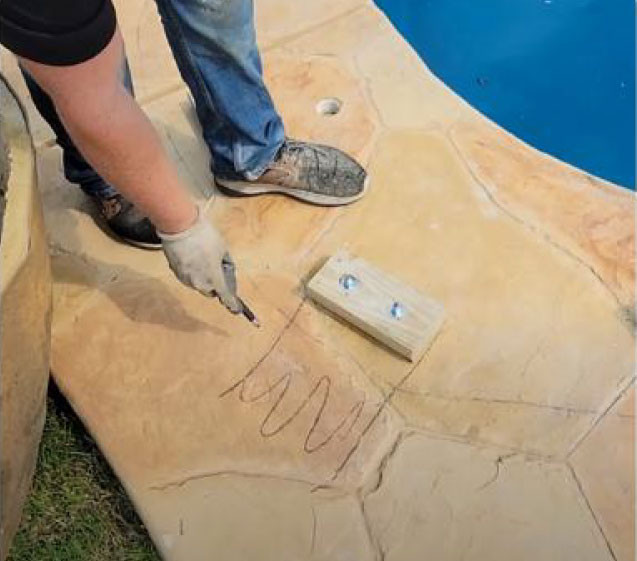 man measuring concrete for rock waterfall pool install