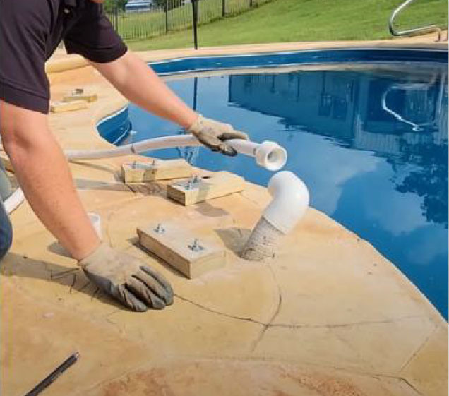 man fitting pipes for rock waterfall install on pool